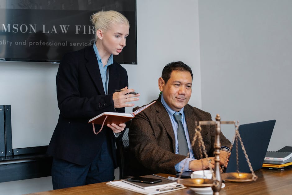 Modern law office with technology focus showing legal professionals working with IT clients